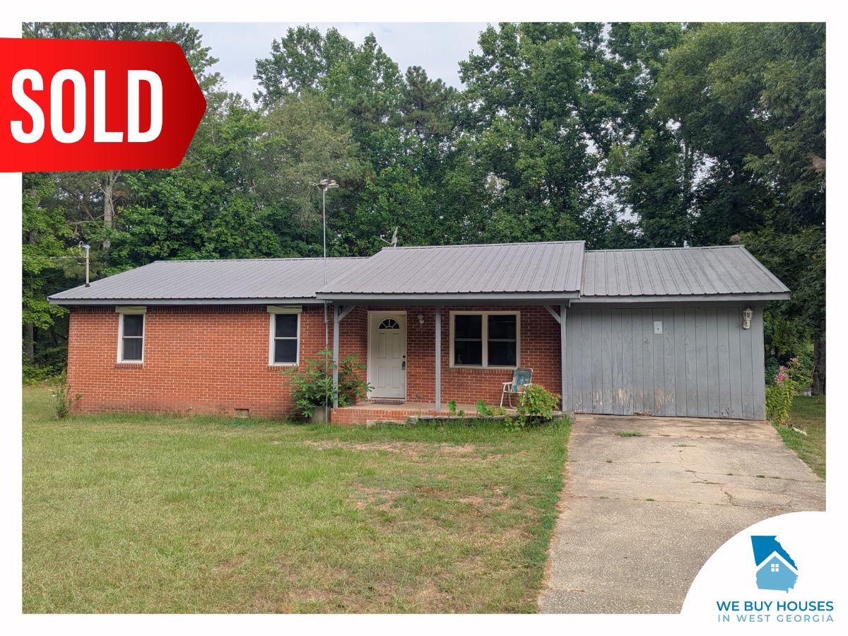A ranch-style red brick house with a closed carport, bought by We Buy Houses in West Georgia