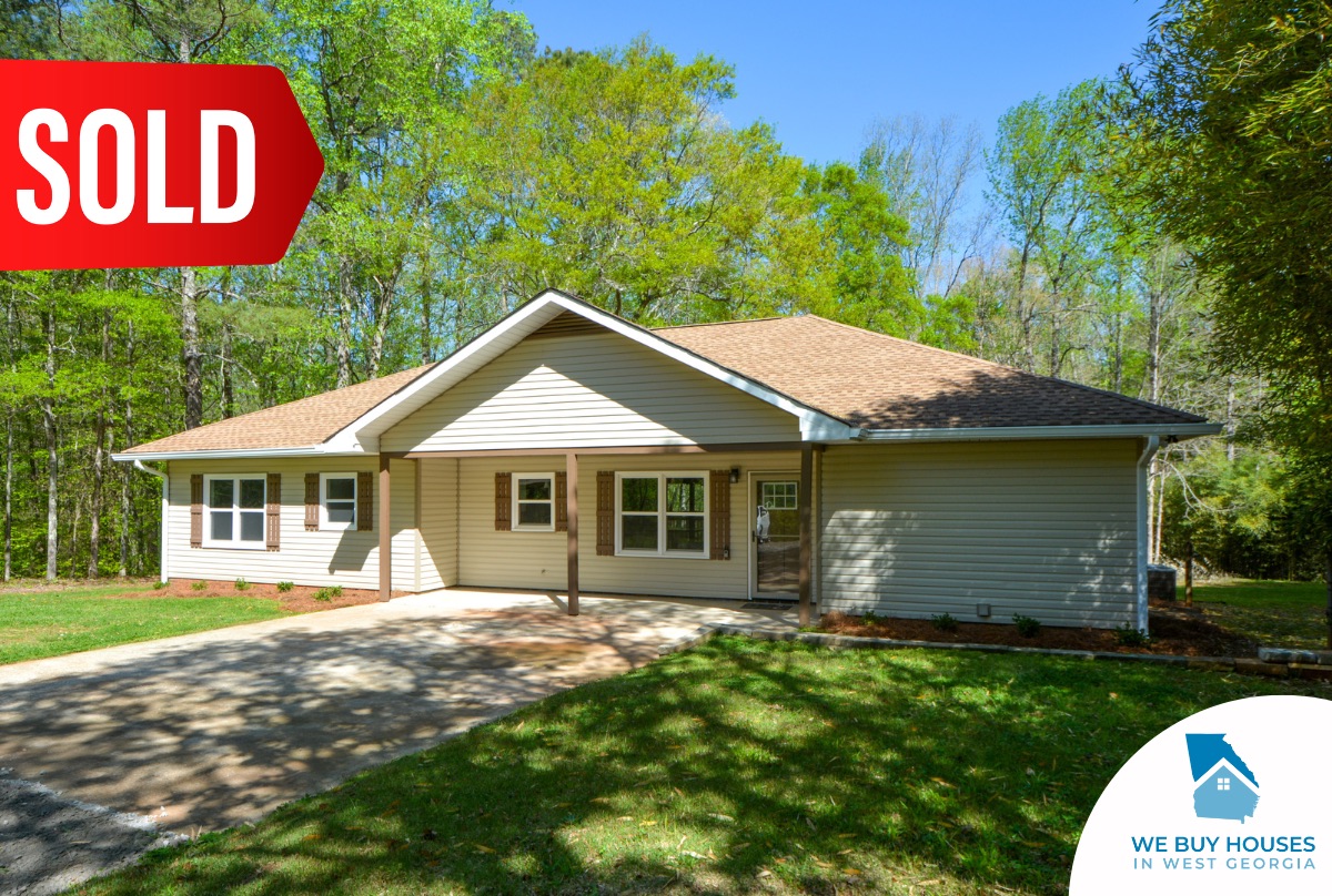 A ranch house with beige siding and wooden shutters bought by We Buy Houses in West Georgia